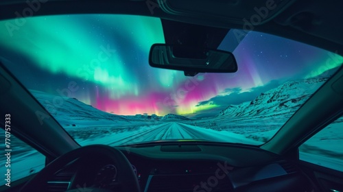 View from inside of a car in wild snow field with beautiful aurora northern lights in night sky with snow forest in winter.