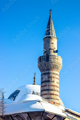 Winter scene of Lalapasa Mosque in Erzurum with snowy dome and minaret photo