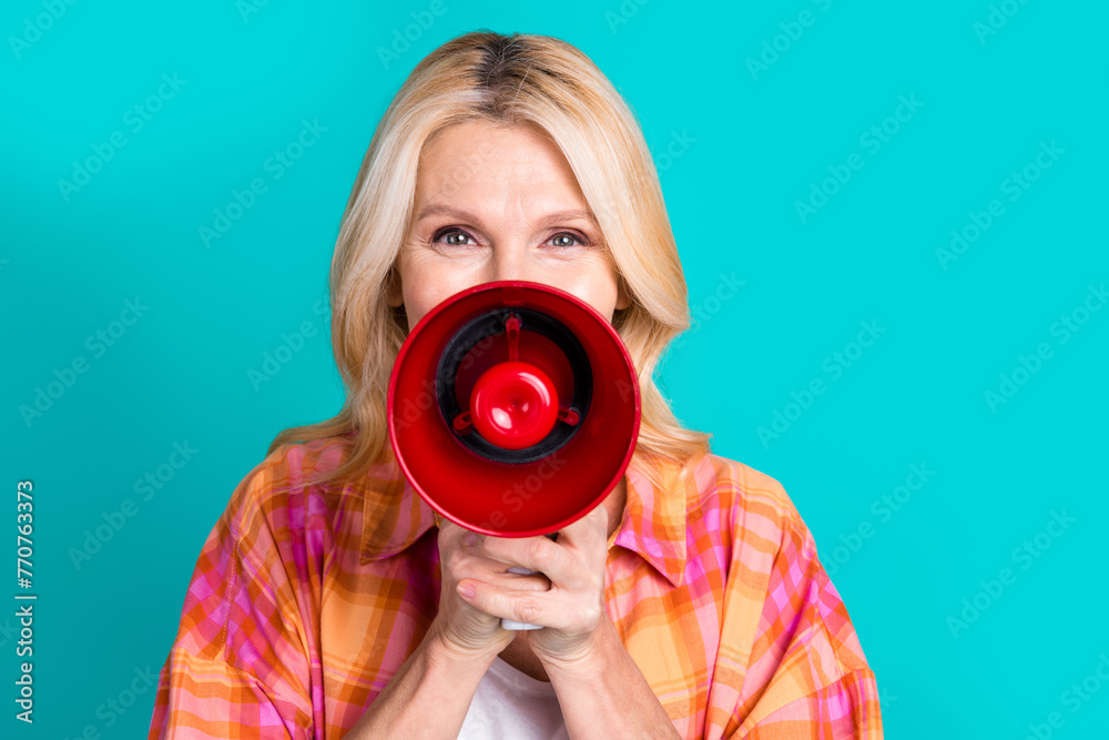 Obraz premium Photo of positive person with blond hair dressed checkered shirt announcing sale in red megaphone isolated on teal color background
