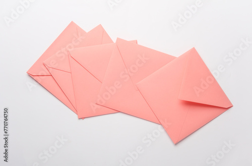 Pink square paper envelopes on white background