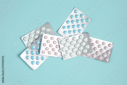 Many blisters of tablets on a blue background. Medicine concept