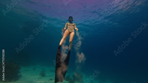 Young fit woman swims underwater on a breath hold. Sexy woman freediver swims underwater © Dudarev Mikhail