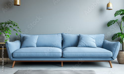 A chic, modern living room featuring a vibrant blue sofa, stylish pendant lights, and a touch of greenery.