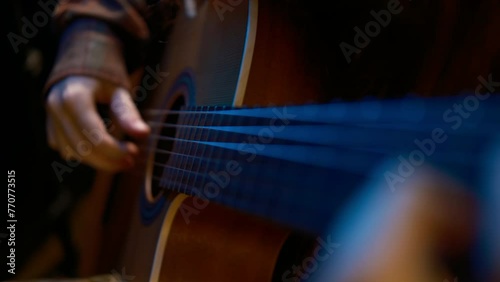 Cinematic. Guitar in studio blue dark light. Play Music. Close up classic guitar indoors 4k photo