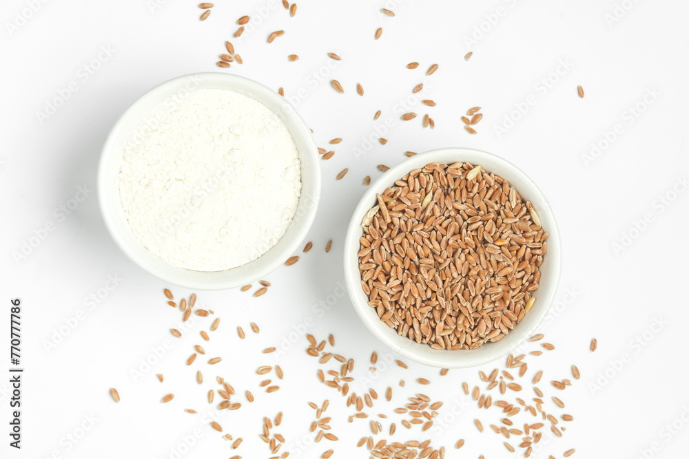 Bowl with wheat grains and flour on white background