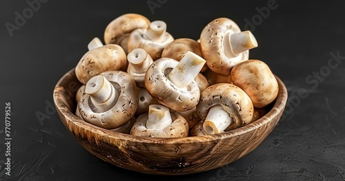 Button Mushrooms Displayed in Wooden Bowl on Black Wood Table