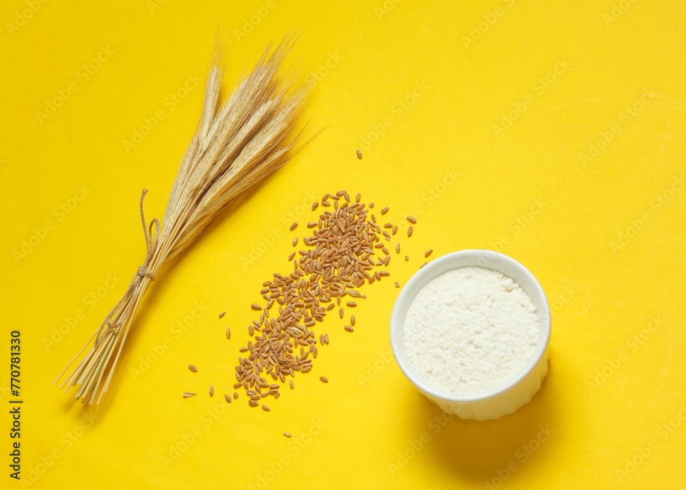Spikelets of wheat, grains and flour on yellow background. Spikelets of wheat, grains and flour on yellow background.