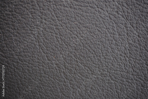 Car seat black natural leather texture extreme close-up 