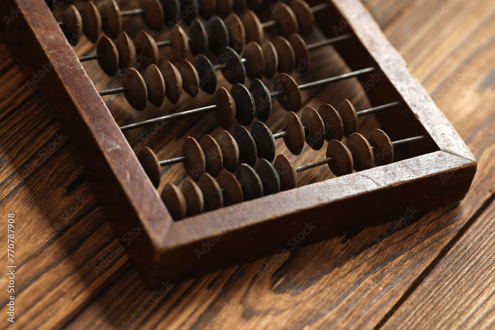 Close up of wooden abacus on wooden table Close up of wooden abacus on wooden table