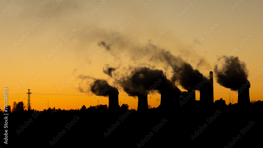 Fototapeta premium Coal power plant silhouette at sunrise, South Africa