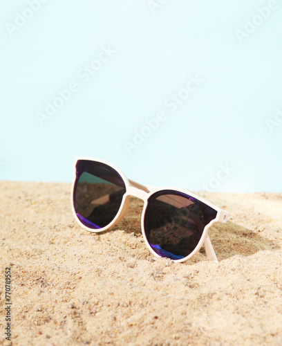 Stylish sunglasses on the sand. Beach vacation