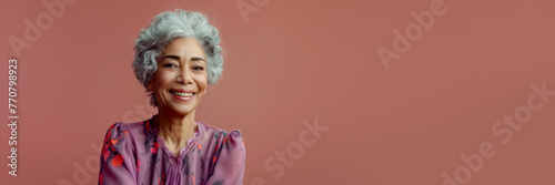 Stylish senior well-groomed African American woman derssed in fashionable expensive clothes on bright pink background, copy space, web banner photo