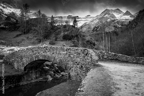 Sunset over the Pyrenees mountains, Circus of Gavarnie and the old stone bridge spanning the stream, High quality photo photo