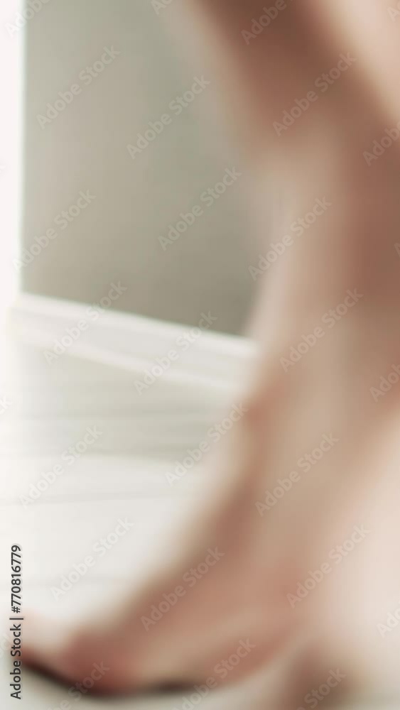 A sexy half-naked girl in lingerie and a white shirt playfully enters the bedroom. Selective focus. Vertical video. A sexy half-naked girl in lingerie and a white shirt playfully enters the bedroom. Selective focus. Vertical video.