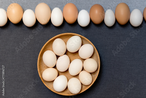 Fresh brown and small chabo chicken eggs on grey background. photo