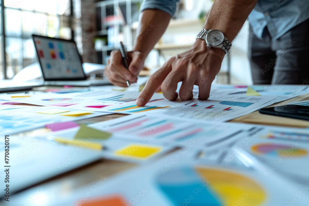 Marketing team collaboratively brainstorming over colorful sticky notes on a whiteboard in a creative office.