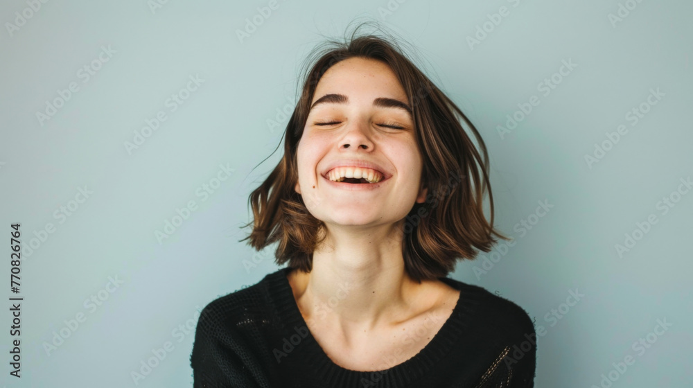 Spanish woman with closed eyes against a clean studio background Spanish woman with closed eyes against a clean studio background