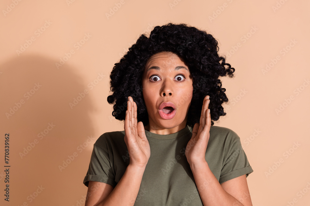 Photo portrait of pretty young woman frightened raise hands dressed trendy khaki outfit isolated on beige color background Photo portrait of pretty young woman frightened raise hands dressed trendy khaki outfit isolated on beige color background