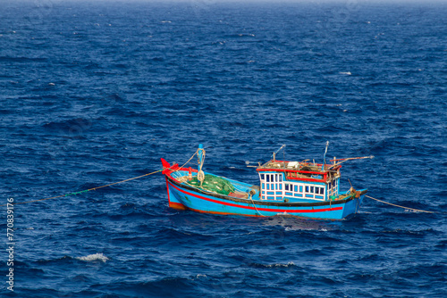 Traditional Wooden Fishing Boat On The Blue Sea.