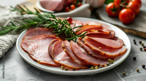 Sliced ham on a table in a white plate