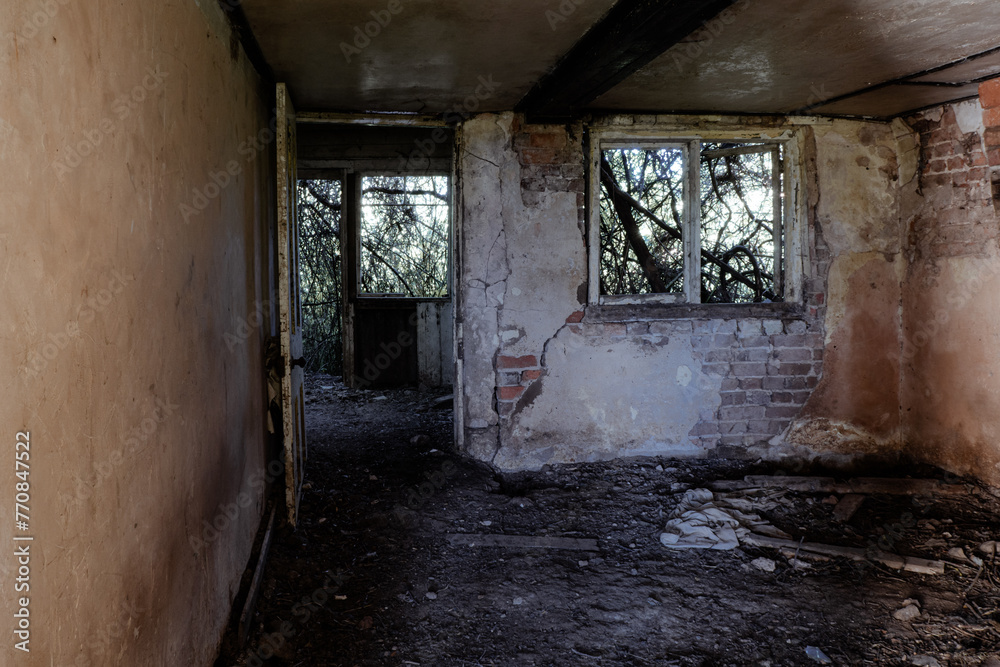 Inside a spooky eerie ruined abandoned house. With broken windows and doors in the countryside
