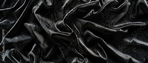 Luxurious black velvet texture with a subtle shimmer under soft lighting