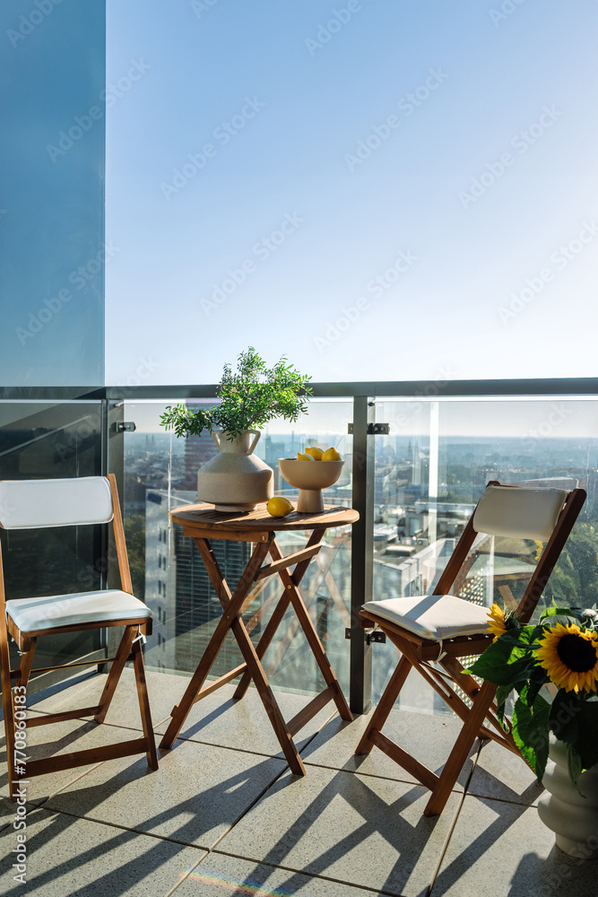Fototapeta premium Vertical shot of outdoor balcony with cityscape of the urban residence.