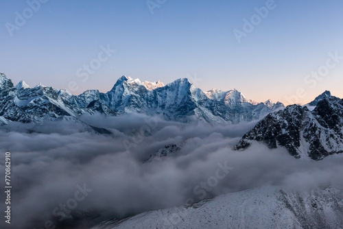 Beutiful mountain landscape in Himalayas, Nepal. High mountain peaks rising above the clouds. View from Gokyo valey, Everest area.