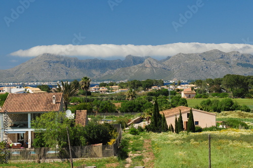 View From Alcudia To The Cloudy Tramuntana Mountains Mallorca On A Wonderful Sunny Spring Day With A Clear Blue Sky