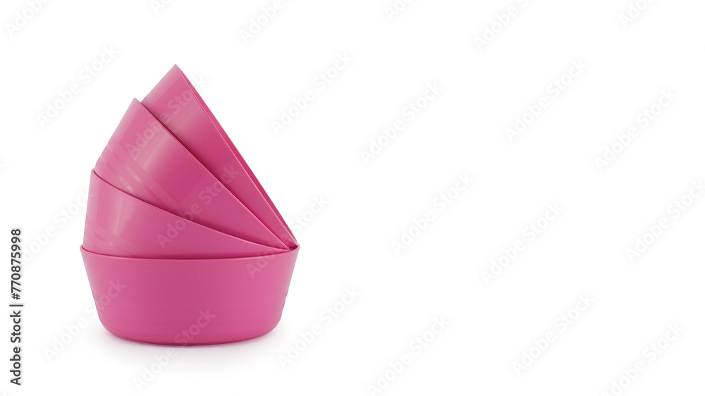 Fototapeta premium Stack of reusable pink plastic bowls, colourful and bright, graphic prawn shape isolated on white background. Concept of fun children’s food, eco-friendly parties and picnics, reusable tableware.