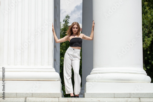 Full length portrait of a young girl in white pants
