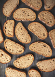 Assorted sliced artisan bread on wooden background
