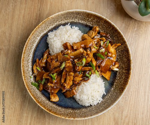 Delicious teriyaki chicken over rice in elegant bowl