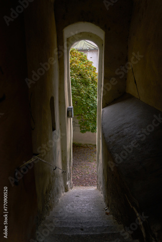 Narrow Old Passageway in Europe. A doorway onto an alley at the end of a narrow passageway in a historic medieval European town.

