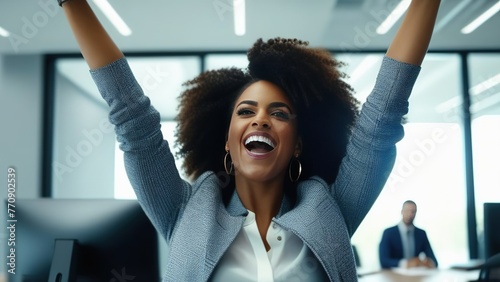 A successful business woman raises her hands up and rejoices at the increase in business profits. Business woman receives good news and raises her hands and shows her fists.