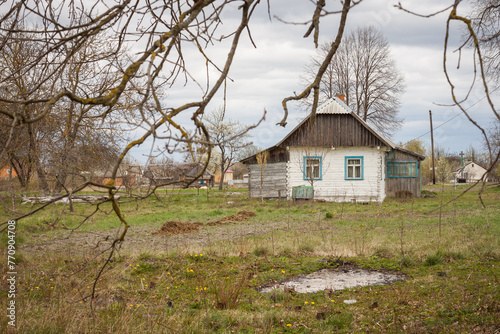 Old rural wooden house. Rural spring landscape. Ukraine