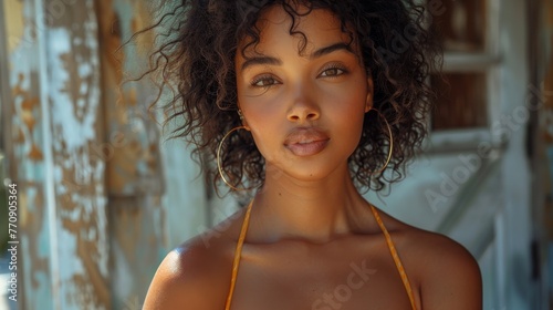 a black sexy woman with curly hair looking to camera with a smile