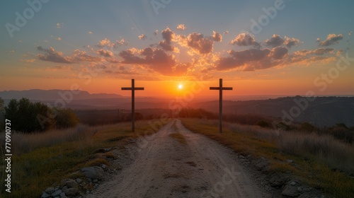  A dirt road dotted with two crosses Sun setting in the distance