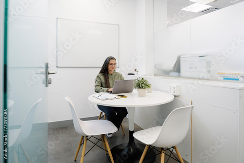 Businesswoman typing keyboard of laptop at office