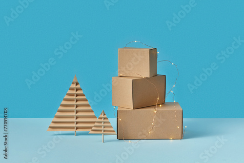 Paper Christmas trees and cardboard boxes decorated with garlands