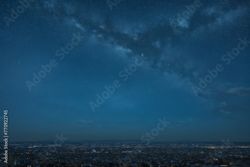 Blue nebula with galaxies, stars and planets over night city. Starry summer skyes over city. photo