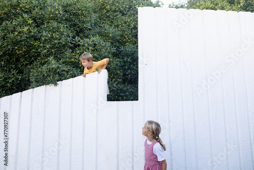 kids at the white garden fence