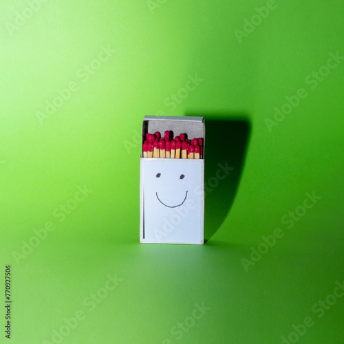 Box of matches with happy face on it. Creative happiness concept with copy space. photo