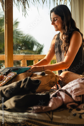 Woman with phone at her topical vacation hotel room