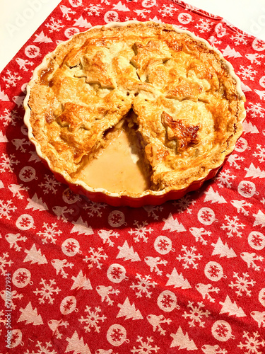 Christmas themed apple pie on a red tablecloth