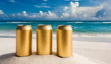 3 golden aluminum can with condensation drops on clear white sand at beach. Beer or soda drink package