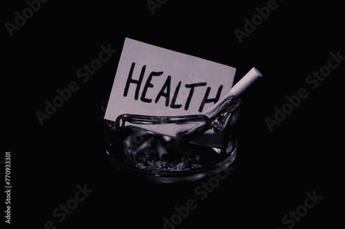 Wallpaper Mural piece of paper with the writing "health" burning due to cigarette smoke in an ashtray, concept of "smoking kills"
 Torontodigital.ca