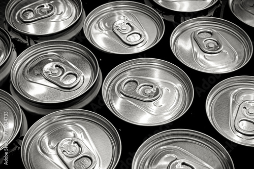 Lots aluminum soda or beer cans as background. Black and white image.