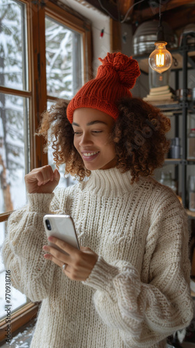 Woman in White Sweater and Red Hat Looking at Cell Phone