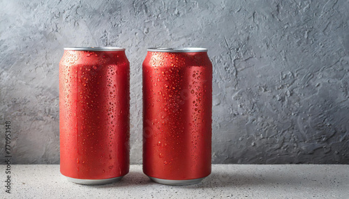 2 red aluminum cans with condensation drops. Beer or soda drink package. Liquid in metallic container.